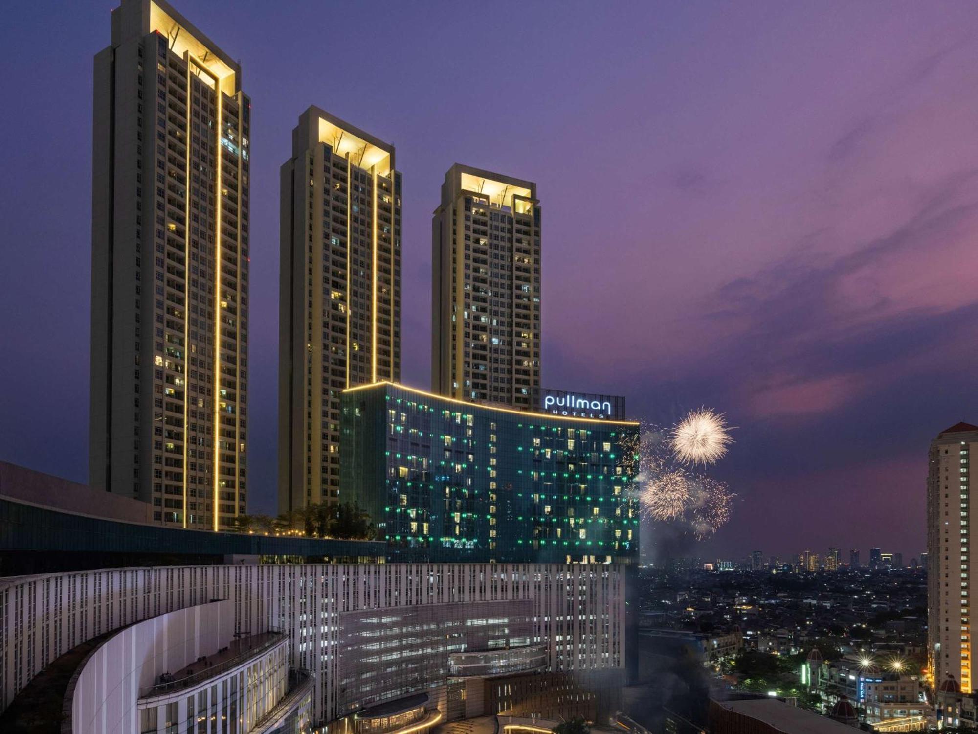 Pullman Jakarta Central Park Экстерьер фото The hotel at night