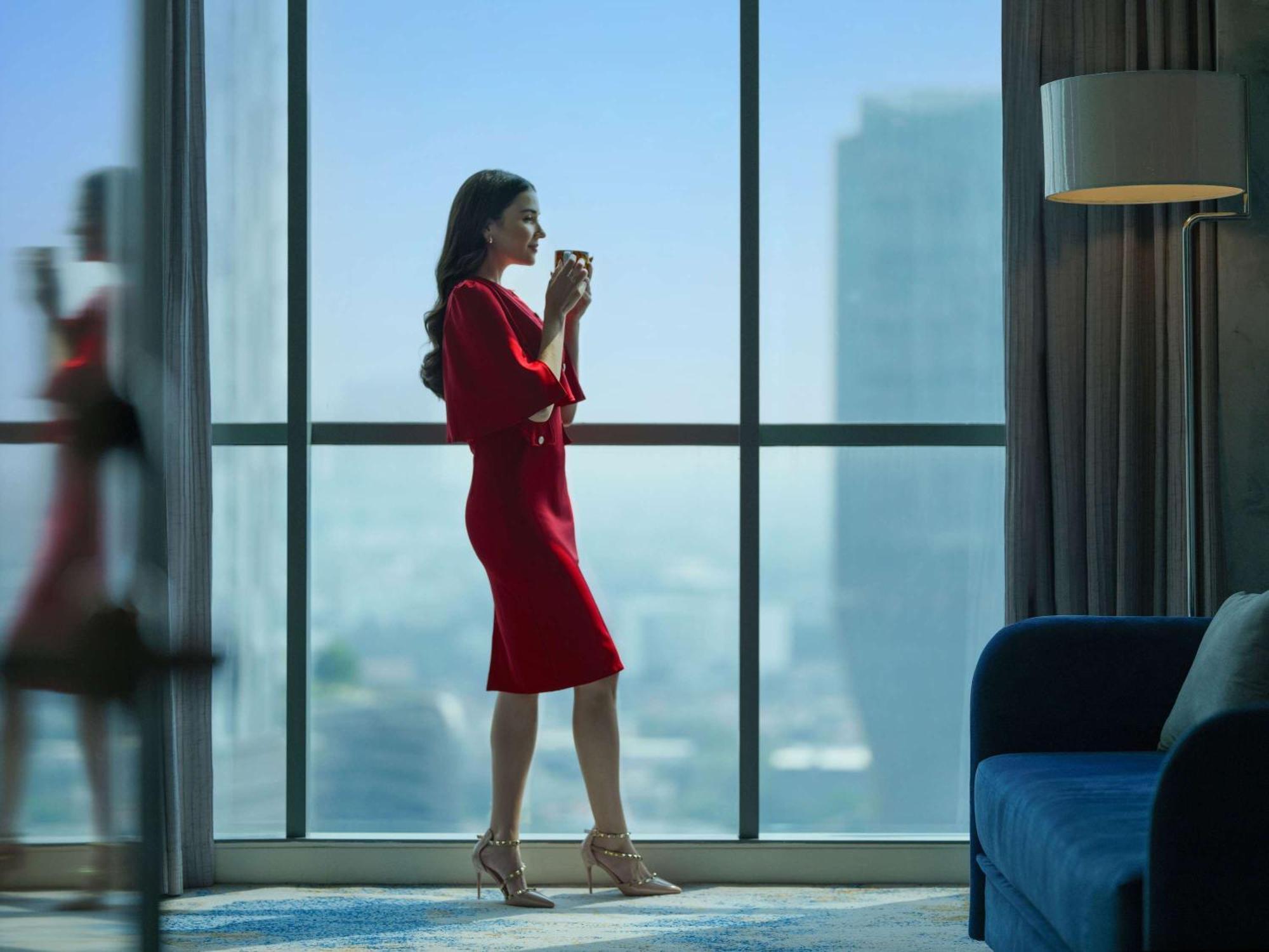 Pullman Jakarta Central Park Экстерьер фото A woman in a red dress